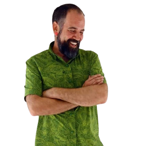Jay Landro smiling in bright green shirt with arms gently folded and head turned to the side